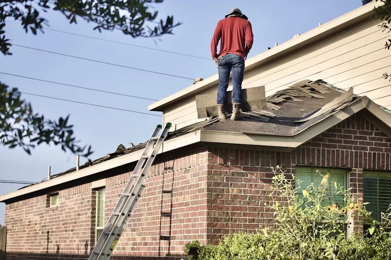 Professional roofer working on a residential roof in Forney